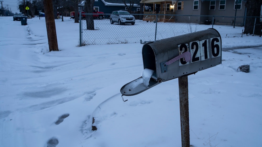 A mailbox is seen frozen in a snow covered neighborhood in Waco, Texas, as severe winter weather conditions forced road closures and power outages over the state on February 17, 2021. / Photo Credit: Matthew Busch/AFP via Getty Images